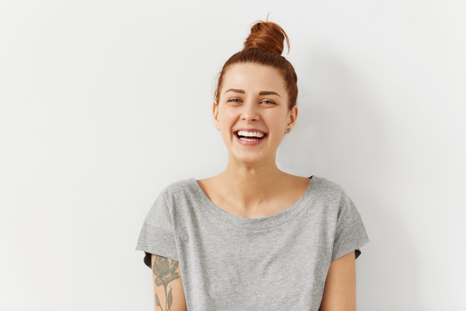 A smiling woman, representing a healthy and happy outcome from dental care when considering Dental Crowns vs. Large Fillings in Brentwood.